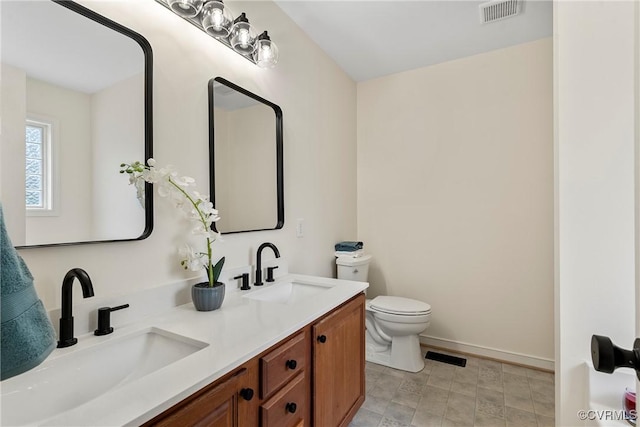 bathroom featuring toilet and vanity