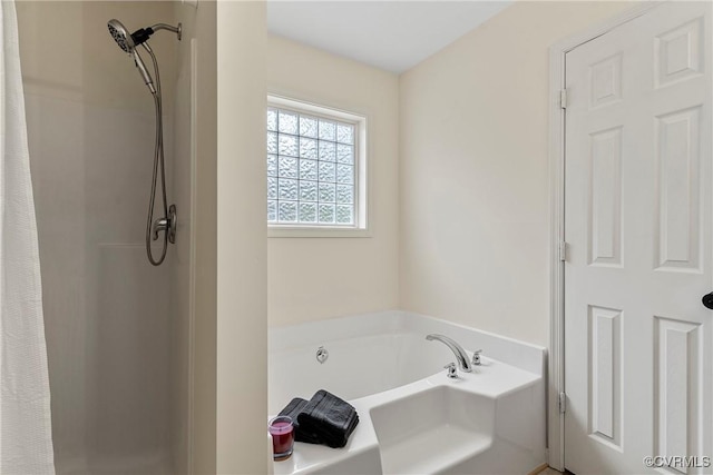 bathroom featuring shower with separate bathtub