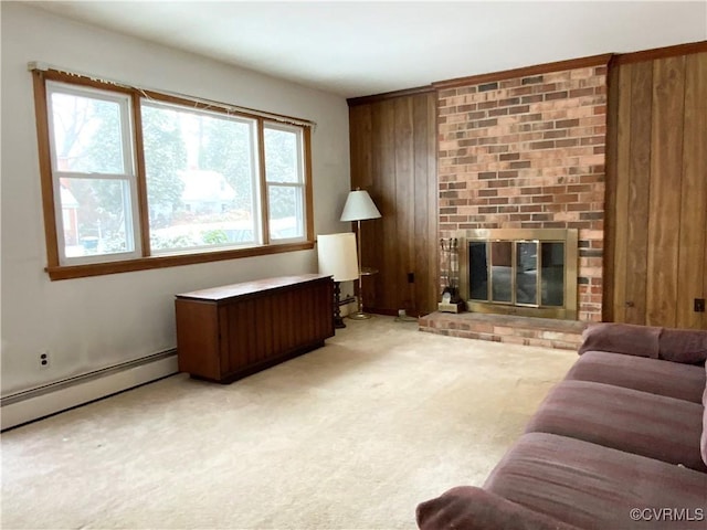 living room with a baseboard heating unit, a brick fireplace, wooden walls, and light colored carpet