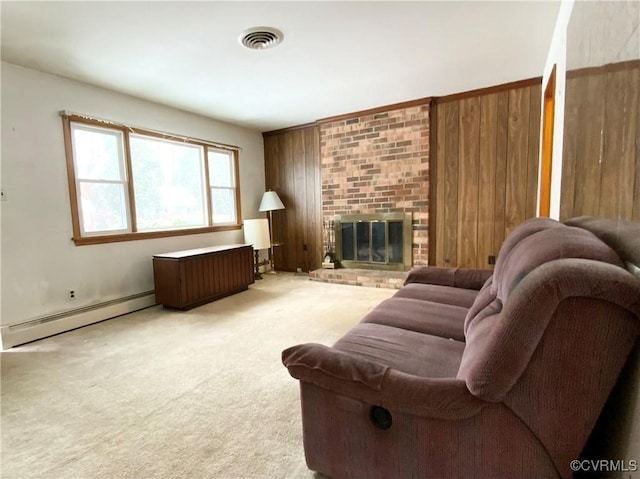 living room with a brick fireplace, carpet, and baseboard heating