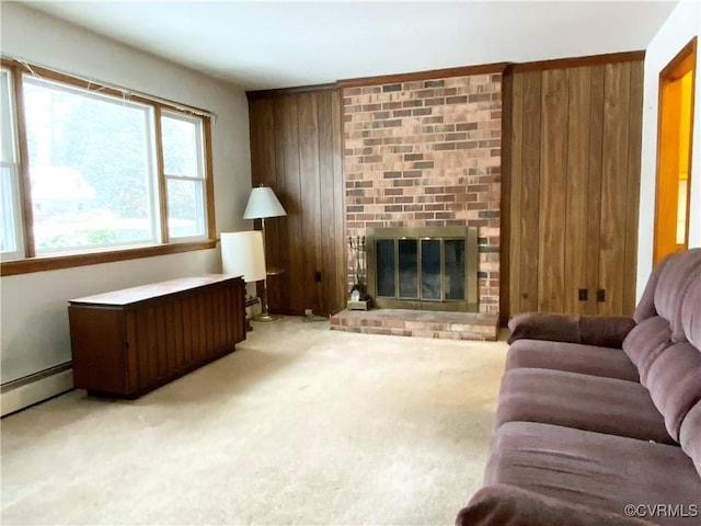 living room featuring wooden walls, a baseboard heating unit, light colored carpet, and a fireplace