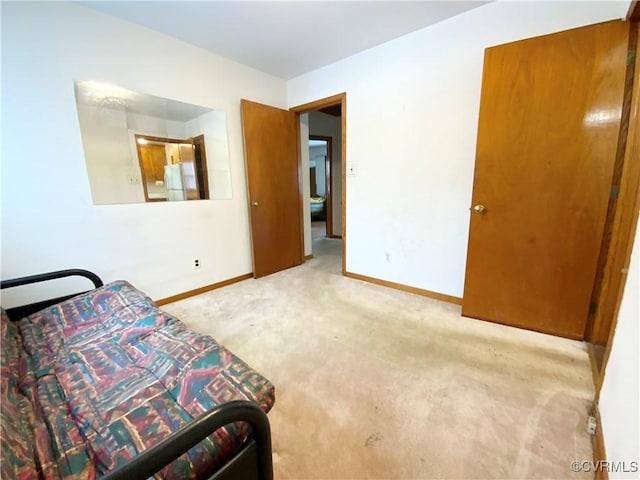 sitting room featuring light colored carpet