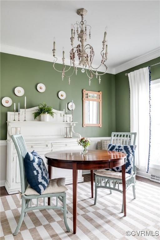 dining room featuring ornamental molding, breakfast area, and a healthy amount of sunlight