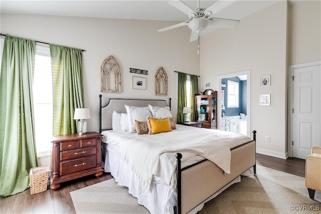 bedroom with ceiling fan, ensuite bathroom, high vaulted ceiling, and dark hardwood / wood-style flooring