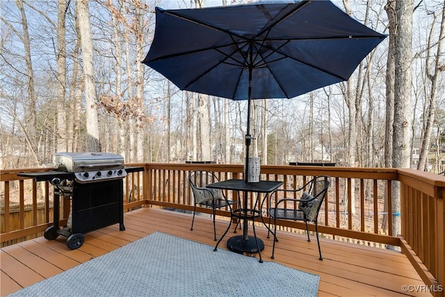 wooden terrace with a grill