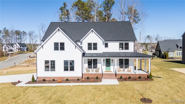 back of property with a lawn and a porch