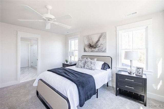 bedroom with ceiling fan and light colored carpet