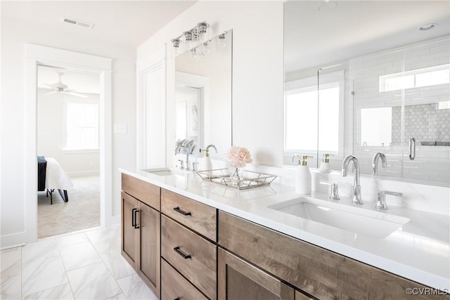 bathroom with vanity and a shower with door