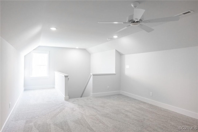 bonus room featuring light carpet, vaulted ceiling, and ceiling fan