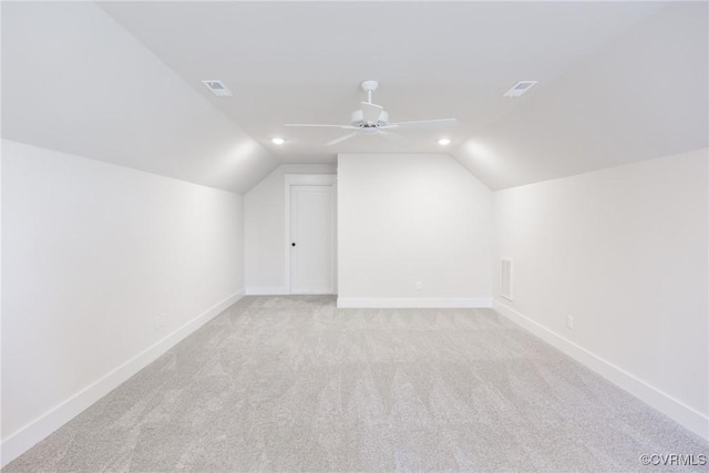 additional living space featuring light carpet, lofted ceiling, and ceiling fan