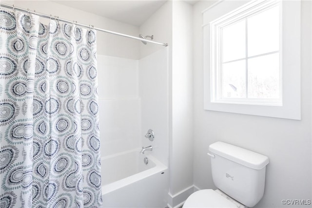 bathroom featuring shower / bathtub combination with curtain and toilet