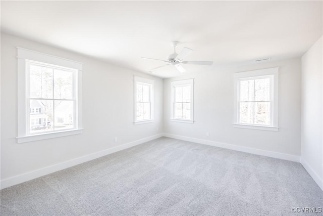 unfurnished room featuring ceiling fan and carpet