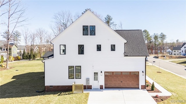 view of front of property featuring a garage and a front yard