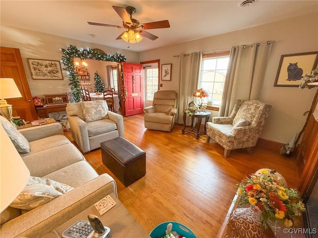 living room featuring hardwood / wood-style flooring and ceiling fan