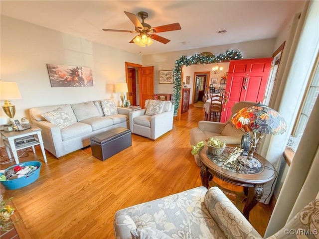 living room featuring light wood-type flooring and ceiling fan