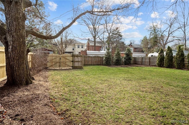 view of yard featuring a gate and a fenced backyard