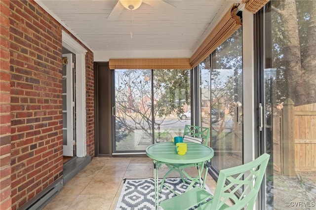 unfurnished sunroom with a baseboard radiator and a ceiling fan