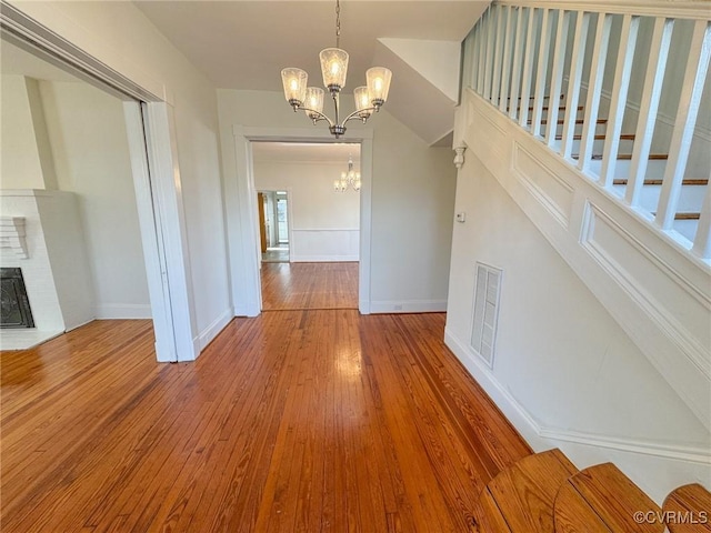 interior space featuring hardwood / wood-style flooring and a chandelier