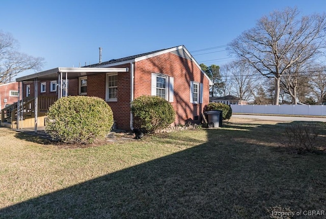 view of side of home featuring a yard