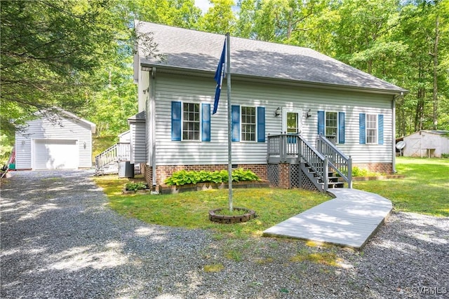 view of front of home featuring an outbuilding, central AC, a shingled roof, and a garage