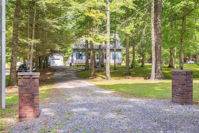 view of property hidden behind natural elements featuring a front lawn