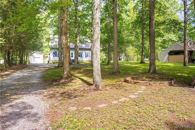 view of front facade with an outdoor structure and a front lawn