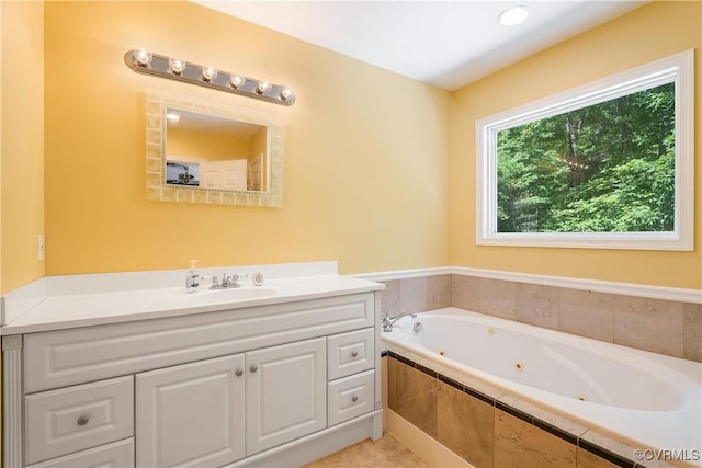 full bath with vanity and a whirlpool tub