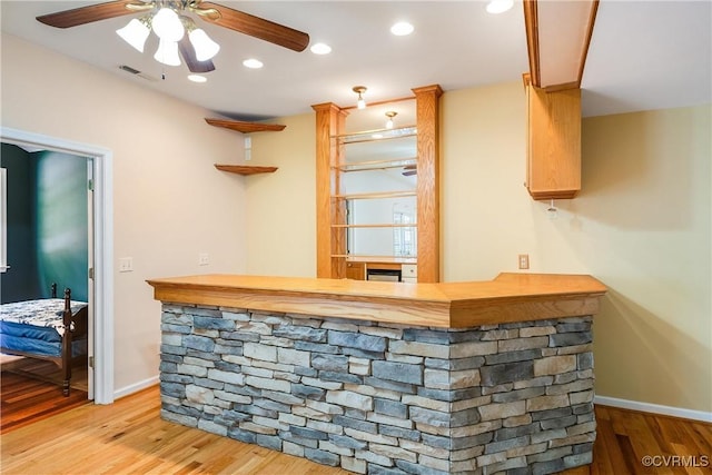 bar featuring baseboards, visible vents, recessed lighting, a bar, and light wood finished floors