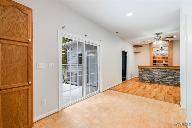 kitchen with baseboards, a ceiling fan, parquet floors, and recessed lighting