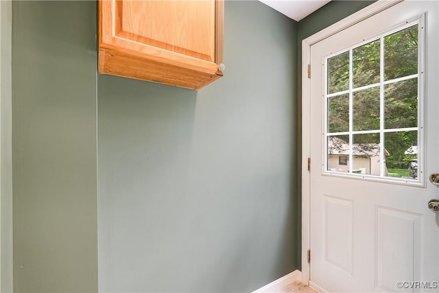 doorway to outside with baseboards