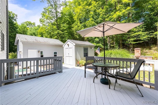 deck with an outbuilding and a storage unit