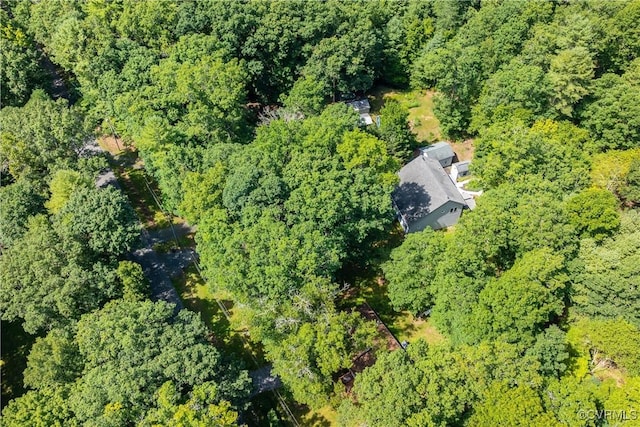 drone / aerial view featuring a wooded view