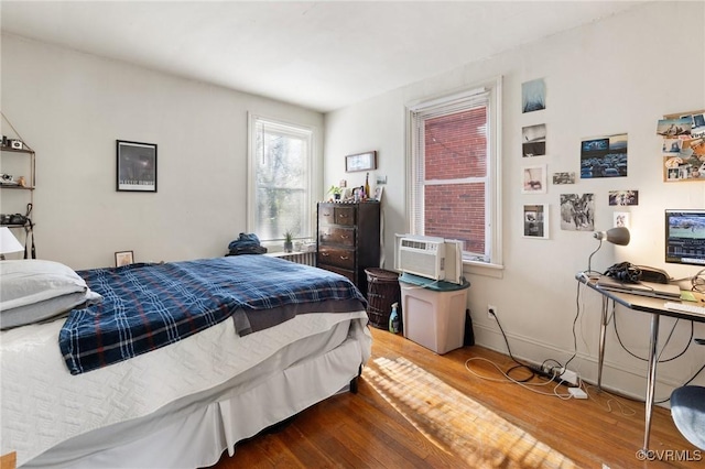 bedroom featuring baseboards and wood finished floors