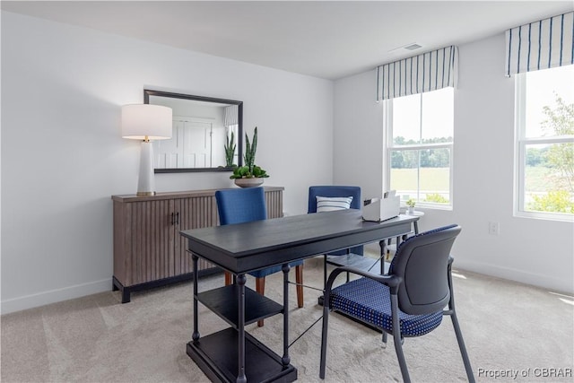 office featuring light carpet, visible vents, and baseboards