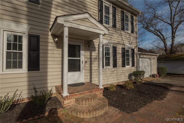 doorway to property with an attached garage