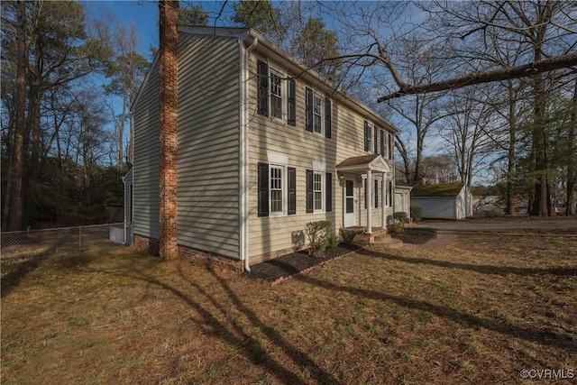 view of home's exterior with a yard and fence