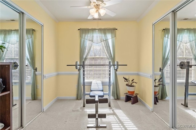 workout room featuring carpet floors, baseboards, and visible vents