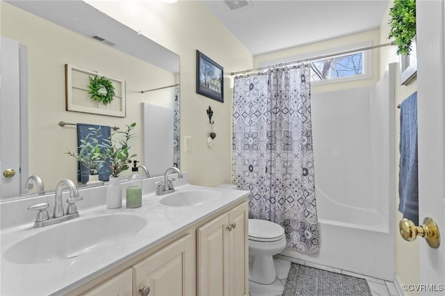 full bathroom featuring visible vents, a sink, toilet, and double vanity