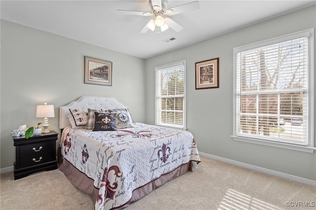 bedroom featuring baseboards, visible vents, carpet flooring, and multiple windows