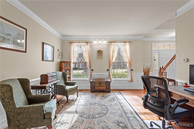 office area featuring a wainscoted wall, light wood finished floors, and crown molding