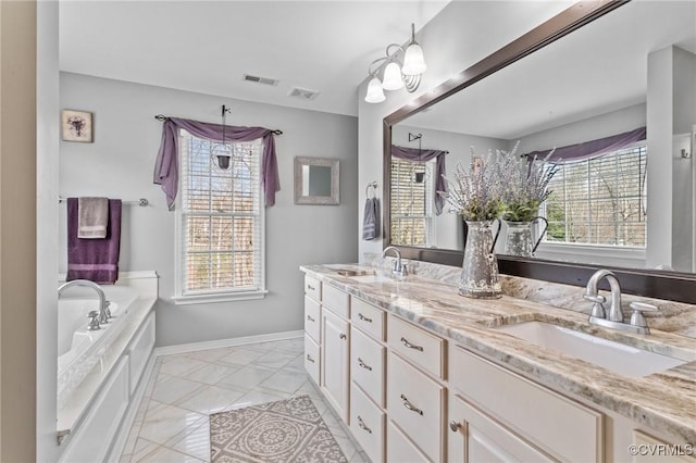 full bathroom featuring a wealth of natural light, visible vents, and a sink