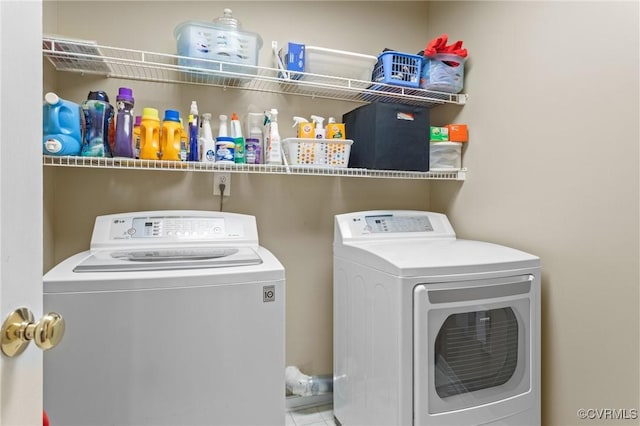 washroom with laundry area and washer and dryer