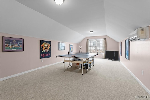 recreation room with vaulted ceiling, carpet floors, a wall mounted air conditioner, and baseboards