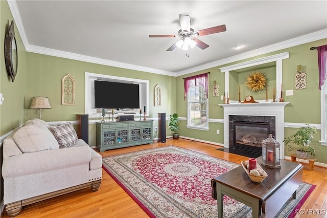 living room with ornamental molding, a fireplace, and wood finished floors