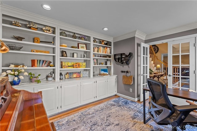 office with ornamental molding, french doors, baseboards, and light wood-style floors