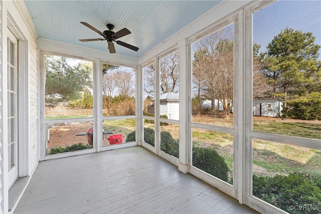 unfurnished sunroom with a ceiling fan