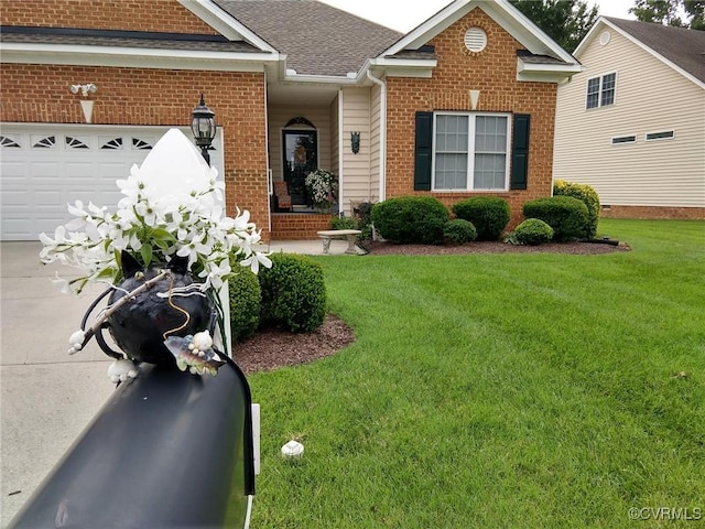 view of front of home featuring a garage, roof with shingles, a front yard, and brick siding