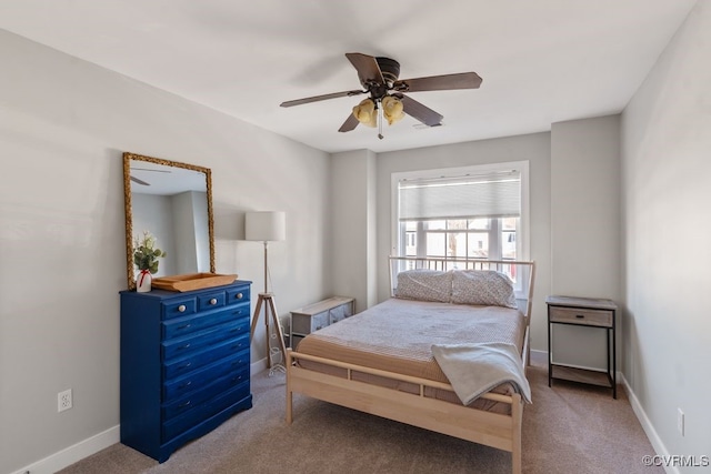 carpeted bedroom featuring ceiling fan and baseboards