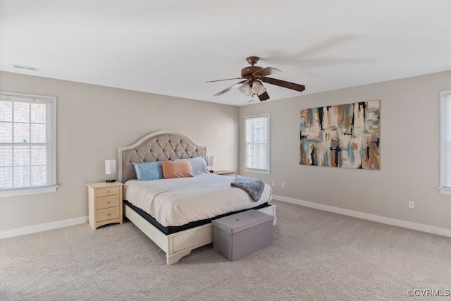 bedroom featuring visible vents, baseboards, and light colored carpet