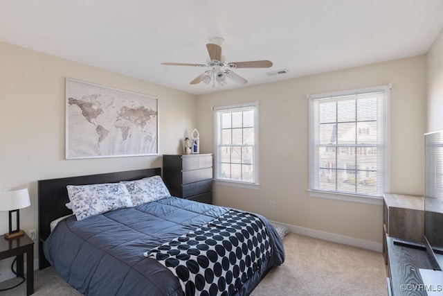 carpeted bedroom featuring visible vents, ceiling fan, and baseboards